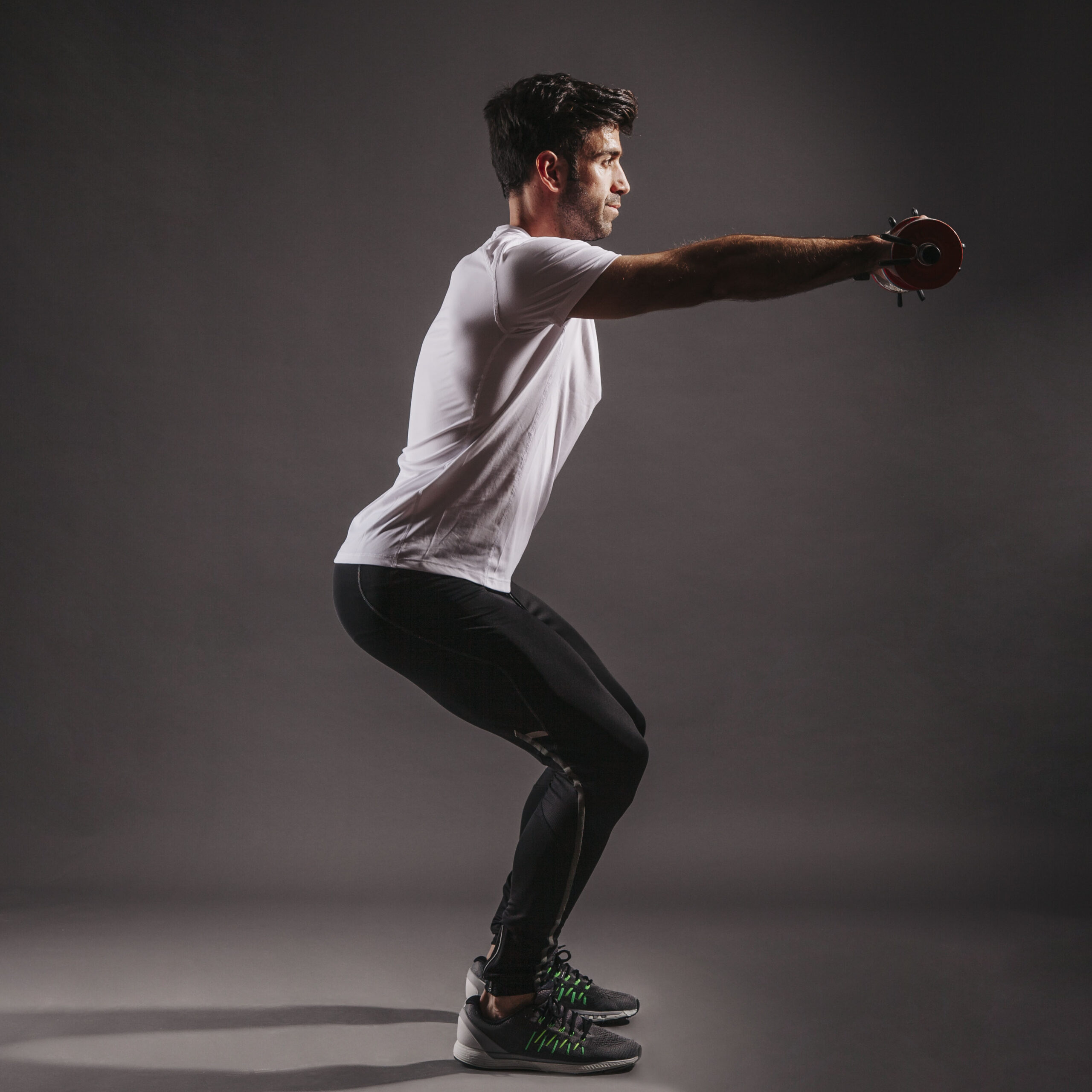 man-squatting-with-dumbbells